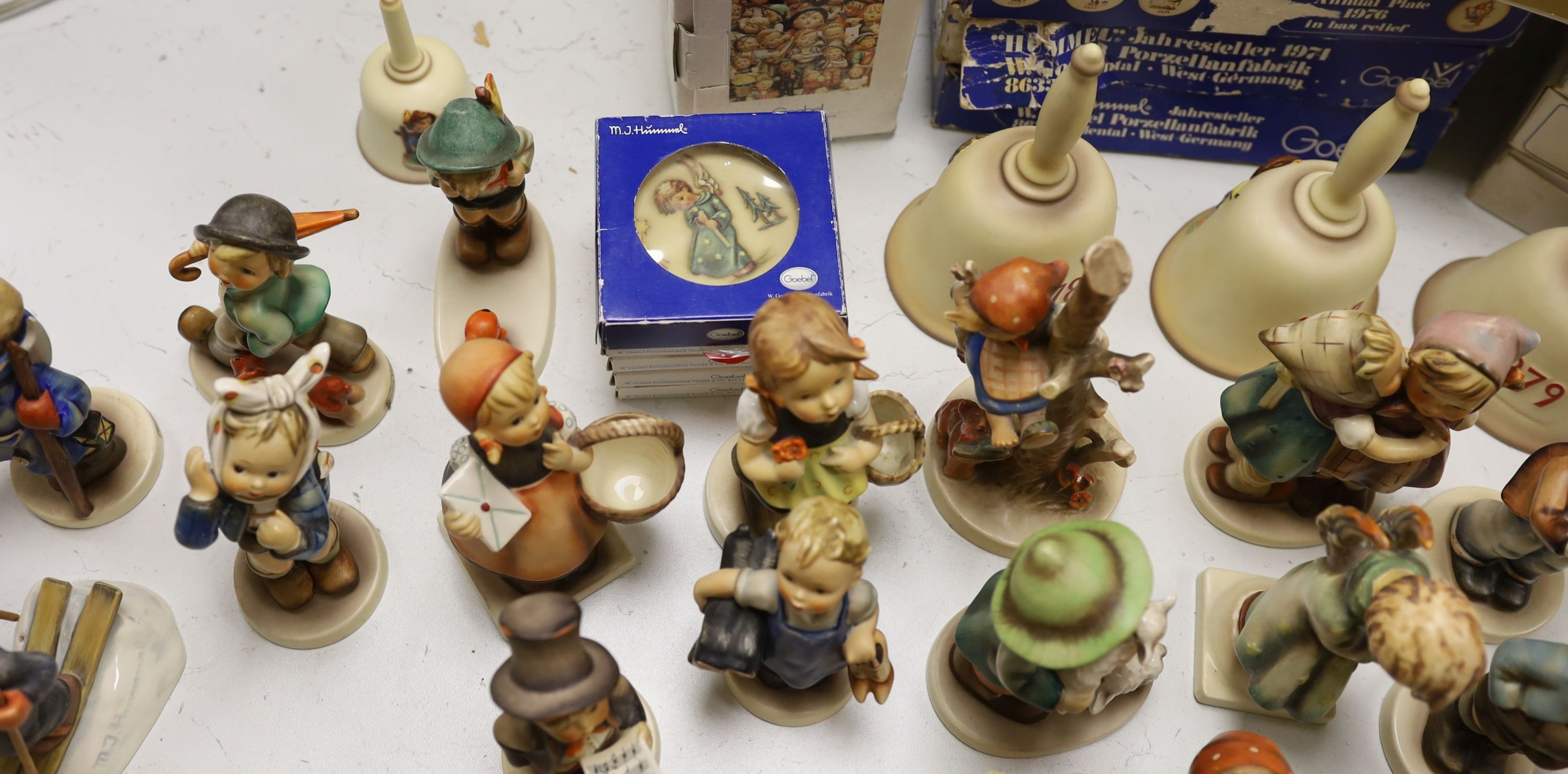 A large collection of Hummel pottery figures, approximately 70 including skier and two similar plaques, some with boxes.